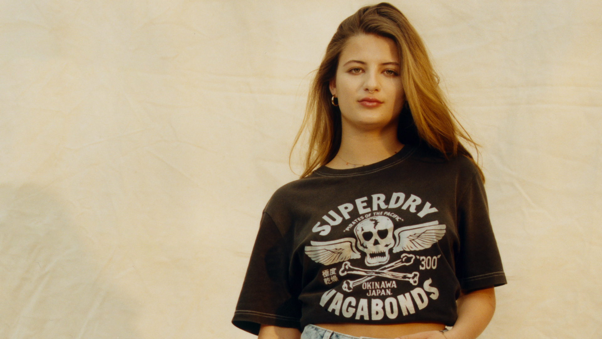 Young woman wearing a black Superdry Vagabonds t-shirt